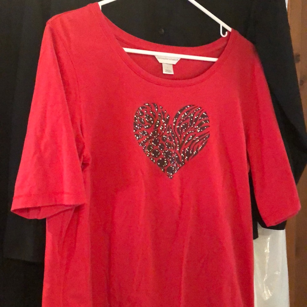 Red shirt with brown heart.